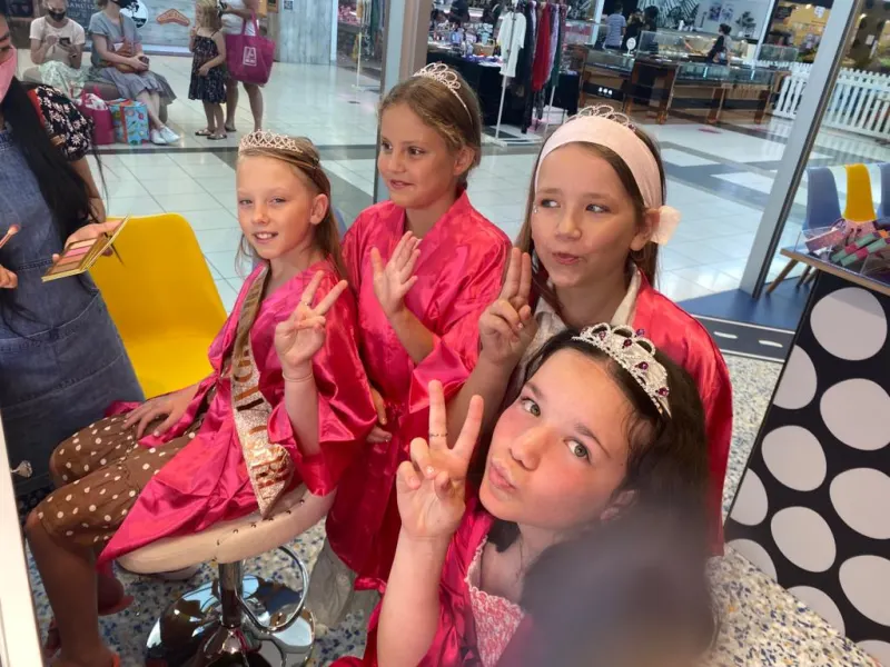Friends in pink robes at a StarKids spa party